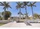 A well-kept dock provides waterfront access, complemented by the home and palm trees in the background at 417 41St Ave, St Pete Beach, FL 33706