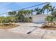 Single-story home with a brick driveway and attached two-car garage framed by mature palms at 417 41St Ave, St Pete Beach, FL 33706