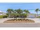 Charming single-story home boasts lush landscaping, decorative palms, and a circular brick driveway at 417 41St Ave, St Pete Beach, FL 33706