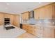 Modern kitchen features wooden cabinets, granite countertops, stainless steel appliances, and tile backsplash at 417 41St Ave, St Pete Beach, FL 33706