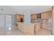 Open kitchen features wooden cabinets, granite counters, stainless steel appliances, and tiled flooring at 417 41St Ave, St Pete Beach, FL 33706