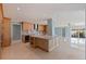 Spacious kitchen with a large island, wooden cabinets, stainless steel appliances, and tile flooring at 417 41St Ave, St Pete Beach, FL 33706