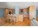 Spacious kitchen with a large island, wooden cabinets, stainless steel appliances, and hardwood floors at 417 41St Ave, St Pete Beach, FL 33706