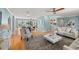 Open-concept living area combining dining and living spaces, featuring hardwood floors and stylish decor at 417 41St Ave, St Pete Beach, FL 33706
