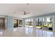 Spacious living room with tile floors, modern ceiling fan, and large sliding glass doors to the patio at 417 41St Ave, St Pete Beach, FL 33706