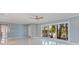 Open living room with tile floors, a ceiling fan, and sliding glass doors leading to outdoor views at 417 41St Ave, St Pete Beach, FL 33706