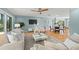 Cozy living space with hardwood floors, ceiling fan, neutral colors and ample seating at 417 41St Ave, St Pete Beach, FL 33706