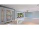 Spacious living room with tile flooring, ceiling fan and large windows offering natural light at 417 41St Ave, St Pete Beach, FL 33706