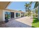 A spacious brick patio with a view of the lawn, canal, and boat dock at 417 41St Ave, St Pete Beach, FL 33706