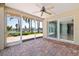 The screened-in patio offers a ceiling fan and brick flooring with water views at 417 41St Ave, St Pete Beach, FL 33706