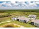 A serene aerial view of a home near a lake, with the community pool and clubhouse visible in the landscape at 43250 Water Bird Way # 5921, Punta Gorda, FL 33982