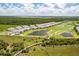 An aerial view of the community featuring homes, ponds, a golf course and lush landscaping at 43250 Water Bird Way # 5921, Punta Gorda, FL 33982
