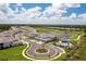 Beautiful aerial view of a community, with a pool, golf course, and manicured landscaping, under a partly cloudy sky at 43250 Water Bird Way # 5921, Punta Gorda, FL 33982