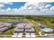 Stunning aerial view of a townhome community with golf course, pool, and serene lake views at 43250 Water Bird Way # 5921, Punta Gorda, FL 33982