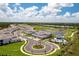 Beautiful aerial view of a Primary-planned community with pool, golf course, and pristine landscaping at 43250 Water Bird Way # 5921, Punta Gorda, FL 33982