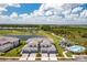Stunning aerial view of a townhome community with golf course, pool, and serene lake views at 43250 Water Bird Way # 5921, Punta Gorda, FL 33982