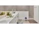 Bathroom featuring double sinks with white countertops, decorative décor, and a tiled walk-in shower at 43250 Water Bird Way # 5921, Punta Gorda, FL 33982