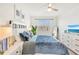 Comfortable bedroom with neutral-colored walls and carpet with a ceiling fan and ample natural light at 43250 Water Bird Way # 5921, Punta Gorda, FL 33982