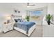 Bright bedroom with a cozy bed, a ceiling fan, and lots of natural light at 43250 Water Bird Way # 5921, Punta Gorda, FL 33982