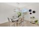 Bright dining room with a modern chandelier, a light-colored table with seating for six and decor at 43250 Water Bird Way # 5921, Punta Gorda, FL 33982