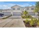 Stylish townhome with a two-car garage, paver driveway, and professionally landscaped front yard with lush plantings at 43250 Water Bird Way # 5921, Punta Gorda, FL 33982