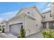 Attractive townhome showing a two-car garage, well-maintained landscaping, and a charming exterior design at 43250 Water Bird Way # 5921, Punta Gorda, FL 33982