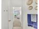 Hallway leading into a bedroom filled with natural light and neutral-colored walls and carpet at 43250 Water Bird Way # 5921, Punta Gorda, FL 33982