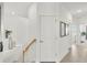 Bright hallway with white walls and stairs leading to a second level at 43250 Water Bird Way # 5921, Punta Gorda, FL 33982