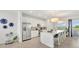 Bright kitchen with stainless steel appliances, a center island with bar seating, and modern white cabinetry at 43250 Water Bird Way # 5921, Punta Gorda, FL 33982