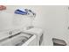 A well-lit laundry room with a washer, dryer and storage shelf for convenience at 43250 Water Bird Way # 5921, Punta Gorda, FL 33982