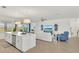 Open-concept living room and kitchen featuring stylish decor, a center island, and access to the outdoor space at 43250 Water Bird Way # 5921, Punta Gorda, FL 33982