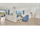 Spacious living room with modern furnishings, a decorative TV console, and sliding glass doors to an outdoor patio at 43250 Water Bird Way # 5921, Punta Gorda, FL 33982