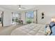 Well-lit main bedroom with a desk near windows and access to a balcony with beautiful outdoor views at 43250 Water Bird Way # 5921, Punta Gorda, FL 33982