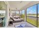 Inviting screened-in patio with comfortable seating, offering serene views of the lake and golf course at 43250 Water Bird Way # 5921, Punta Gorda, FL 33982