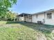 Spacious backyard with green grass, and a covered patio perfect for outdoor entertaining and relaxation at 485 Stillwater Ave, Spring Hill, FL 34606
