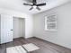 Cozy bedroom features new wood-look flooring, a ceiling fan and closet at 485 Stillwater Ave, Spring Hill, FL 34606