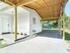 Spacious carport with a wooden beam ceiling, offering ample parking and protection from the elements at 485 Stillwater Ave, Spring Hill, FL 34606