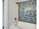Close-up of a bathtub with a tiled wall at 4895 Bay Ne St # 207, St Petersburg, FL 33703