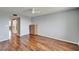 A spacious bedroom with hardwood floors, a ceiling fan, and light gray walls at 4895 Bay Ne St # 207, St Petersburg, FL 33703
