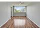 Spacious bedroom with wood floors, ceiling fan, and sliding glass doors to exterior at 4895 Bay Ne St # 207, St Petersburg, FL 33703