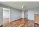 View of a light gray bedroom with hardwood floors, a ceiling fan, and access to other rooms at 4895 Bay Ne St # 207, St Petersburg, FL 33703