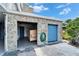 Car wash area with stone walls and blue door, equipped with a hose and garbage bin at 4895 Bay Ne St # 207, St Petersburg, FL 33703