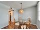 Comfortable dining area with a stylish wicker pendant light and access to a hallway at 4895 Bay Ne St # 207, St Petersburg, FL 33703