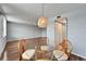 Charming dining space near a doorway, featuring a round glass table with wicker chairs at 4895 Bay Ne St # 207, St Petersburg, FL 33703