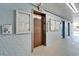 Building elevator access on a light blue textured wall with adjacent community postings, and tile flooring at 4895 Bay Ne St # 207, St Petersburg, FL 33703