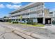Condo building exterior showcasing architectural details, tidy landscaping, and covered parking entrance at 4895 Bay Ne St # 207, St Petersburg, FL 33703