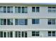 Exterior shot showing a white building with multiple windows, highlighting the facade's architectural style at 4895 Bay Ne St # 207, St Petersburg, FL 33703