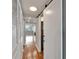 Long hallway with hardwood floors, closets, and a view of the living space and outside at 4895 Bay Ne St # 207, St Petersburg, FL 33703