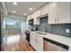 Modern kitchen boasts stainless appliances, white cabinets, quartz counters, and eye-catching subway tile backsplash at 4895 Bay Ne St # 207, St Petersburg, FL 33703