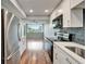 Bright kitchen features stainless appliances, white cabinets, quartz counters, and gray subway tile backsplash at 4895 Bay Ne St # 207, St Petersburg, FL 33703